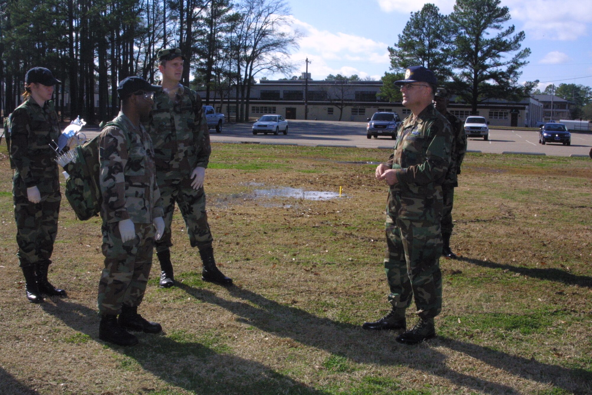 Search and Recovery Team members walk abreast and scan the ground around them after each step as they search for anything that could be remains or personal effects.