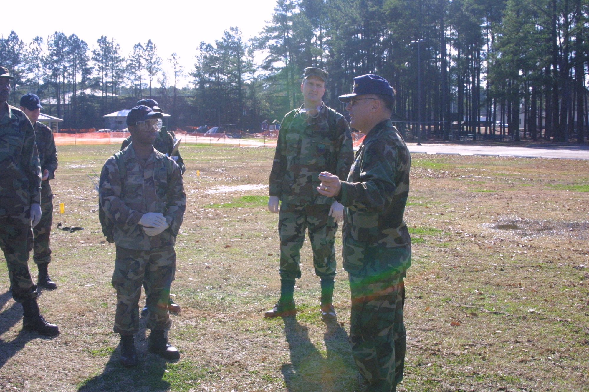 Search and Recovery Team members walk abreast and scan the ground around them after each step as they search for anything that could be remains or personal effects.