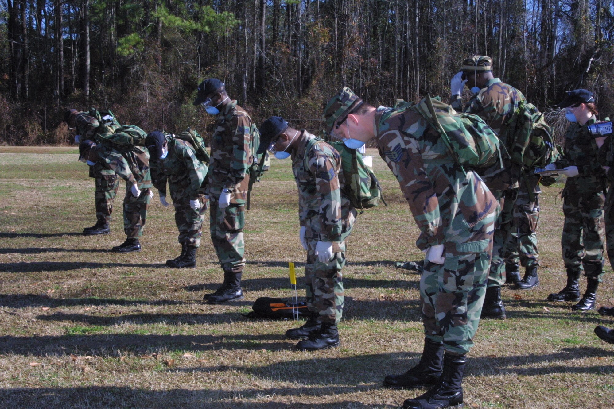 Search and Recovery Team members walk abreast and scan the ground around them after each step as they search for anything that could be remains or personal effects.