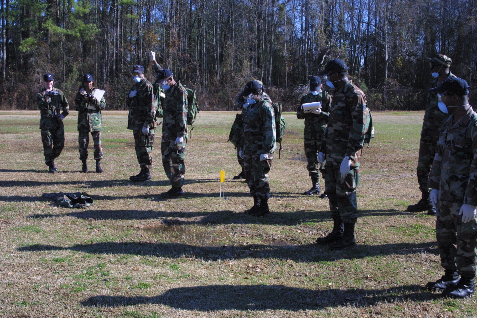 Search and Recovery Team members walk abreast and scan the ground around them after each step as they search for anything that could be remains or personal effects.