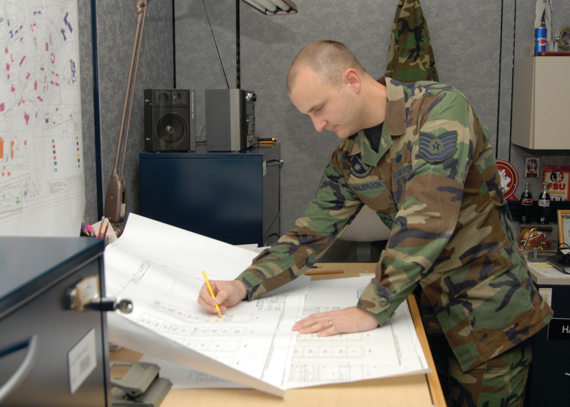 Sergeant Halbrook reviews project cable drawings for a building.