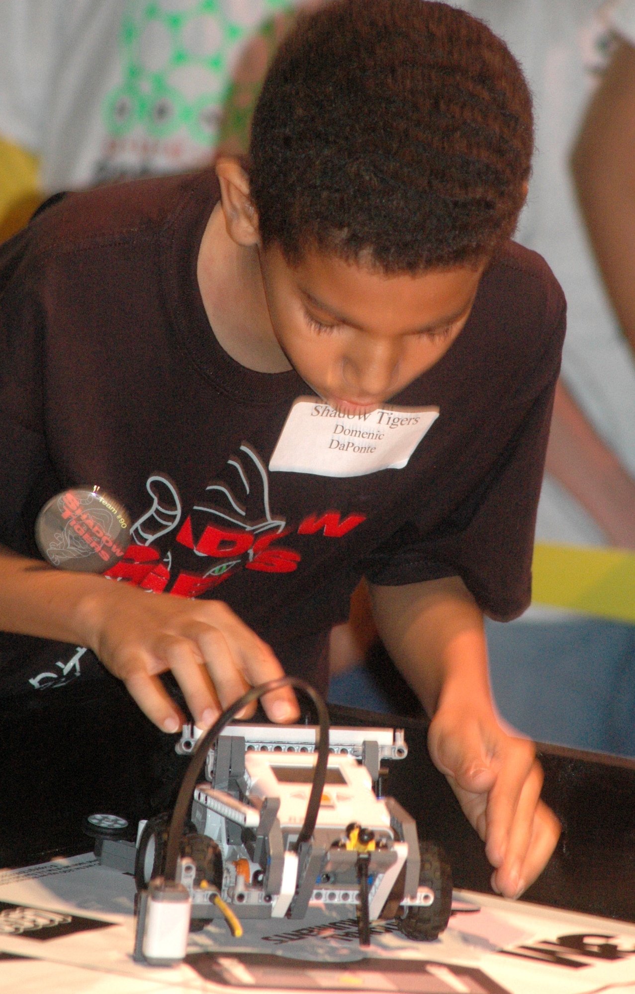 Domenic Daponte of the Shadow Tigers from Marietta resets his robot during first-round competition at the For Inspiration and Recognition of Science and Technology Regional Lego League Robotics competition.   U.S. Air Force photo by Sue Sapp.
