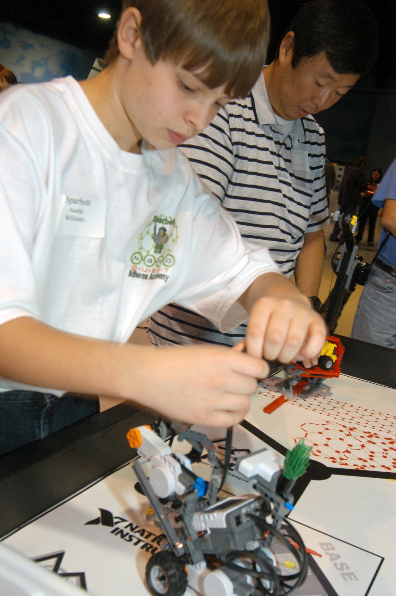 Austin Williams, a member of the Sparbots from Athens,  makes an adjustment to his robot during the robotics competition at Robins Air Force Base.   U.S. Air Force photo by Sue Sapp.