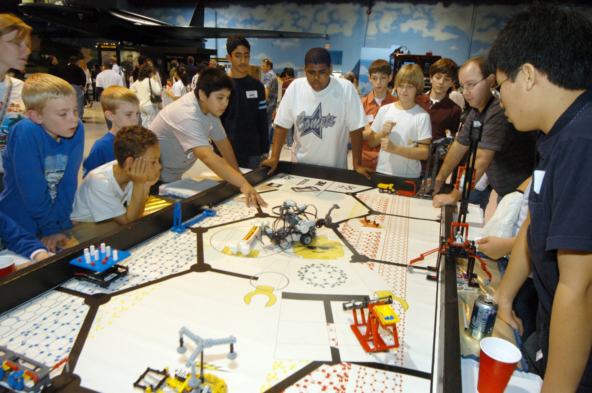 Participants in the FIRST (For Inspiration and Recognition of Science and Technology) Regional Lego League Robotics competition Saturday tweak their robots on a practice table.  U.S. Air Force photo by Sue Sapp.