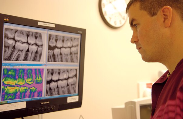 Capt. Nicholas Payne, 23rd Aerospace-Dental Squadron, reads a digital X-ray during a recent exam. Using a soft-bristle toothbrush and applying less pressure when brushing can help prevent tooth abrasions, which can cause severe discomfort. (U.S. Air Force photo by Airman 1st Class Schelli Jones)