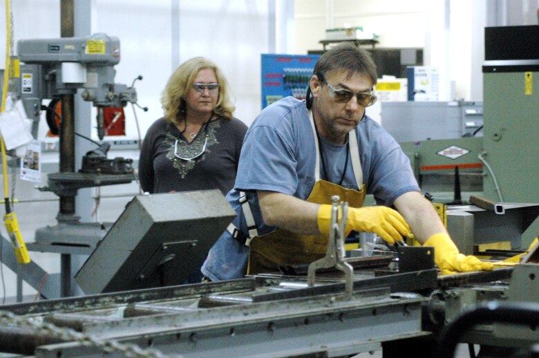 Jackie Keenan, GAP Analysis team for VPP, Savannah River Site, observes Bill Wallace, 402nd MXSG welder, as he performs his job. U.S. Air Force photo by Sue Sapp 
