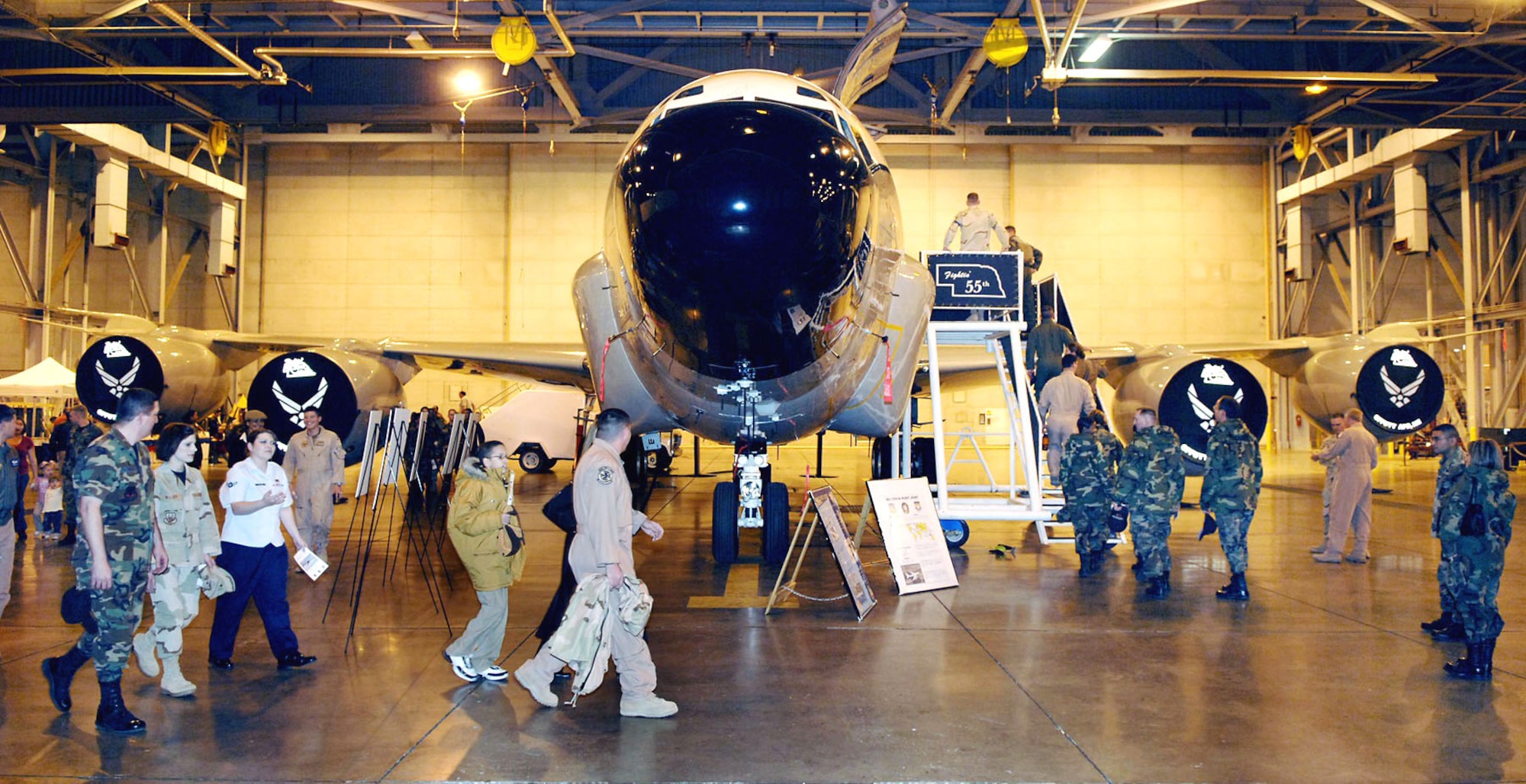 Visitors check out the first RC-135 Rivet Joint aircraft that deployed to Southwest Asia at Offutt Air Force Base, Neb., where the 55th Wing celebrated its 6,000 straight days of deployment to the region during a ceremony Jan. 11. The first RC-135 saw action during Desert Storm in 1990, and elements of the 55th Wing have been continuously deployed to the region since then. (U.S. Air Force photo/Daren Reehl)