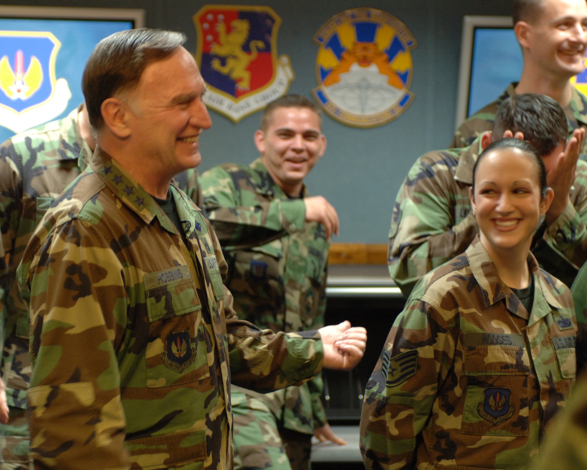 Gen. William T. Hobbins (left) shares a laugh with Airman 1st Class Joshua Peavy (center) and Staff Sgt. Frances Hodges of the 422nd Communications Squadron during the taping of an American Forces Network commercial Jan. 9 at Royal Air Force Croughton, England. General Hobbins is the U.S. Air Forces in Europe commander. (U.S. Air Force photo/Tech. Sgt. Robert Ashley) 