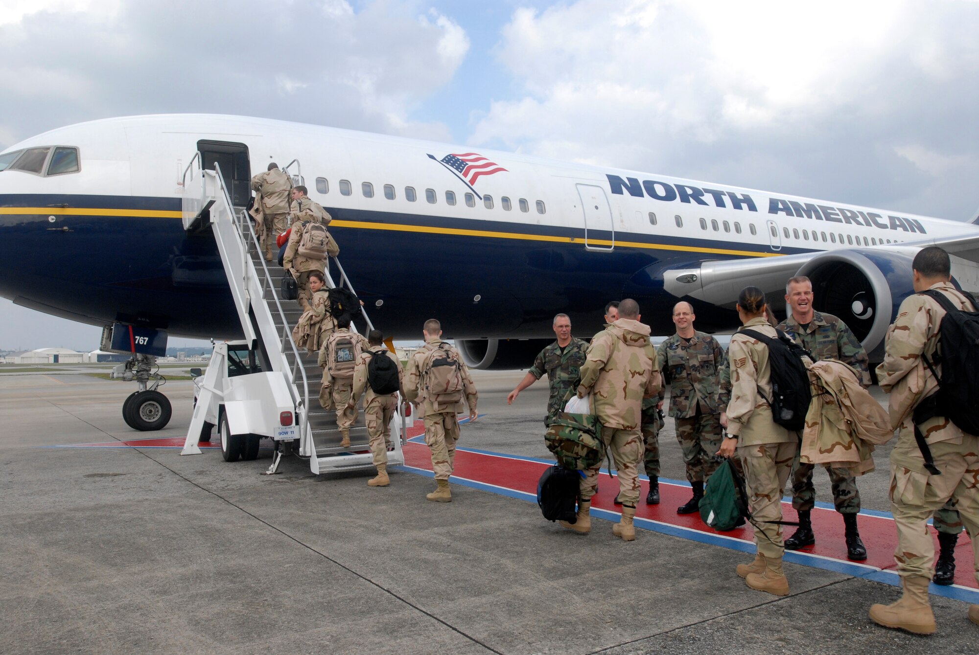 Airmen from Kadena Air Base, Japan, embark Jan. 8 on a commercial aircraft for transport to support the war on terrorism. More than 600 Kadena members are deploying to various locations in the U.S. Central Command's area of responsibility. (U.S. Air Force photo/Airman 1st Class Sheila deVera)