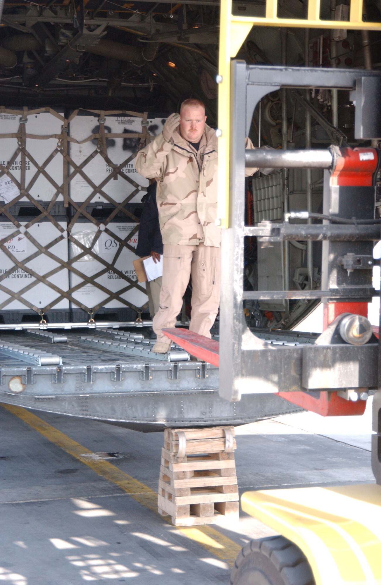 BALAD AIR BASE, Iraq -- Senior Airman Michael Buzbee, 777th Expeditionary Airlift Squadron loadmaster, lines up a forklift prior to off-loading cargo at a stop during a hub-and-spoke mission Jan. 8. Airman Buzbee is deployed from Little Rock Air Force Base, Ark. (U.S. Air Force photo by Senior Airman Josh Moshier)