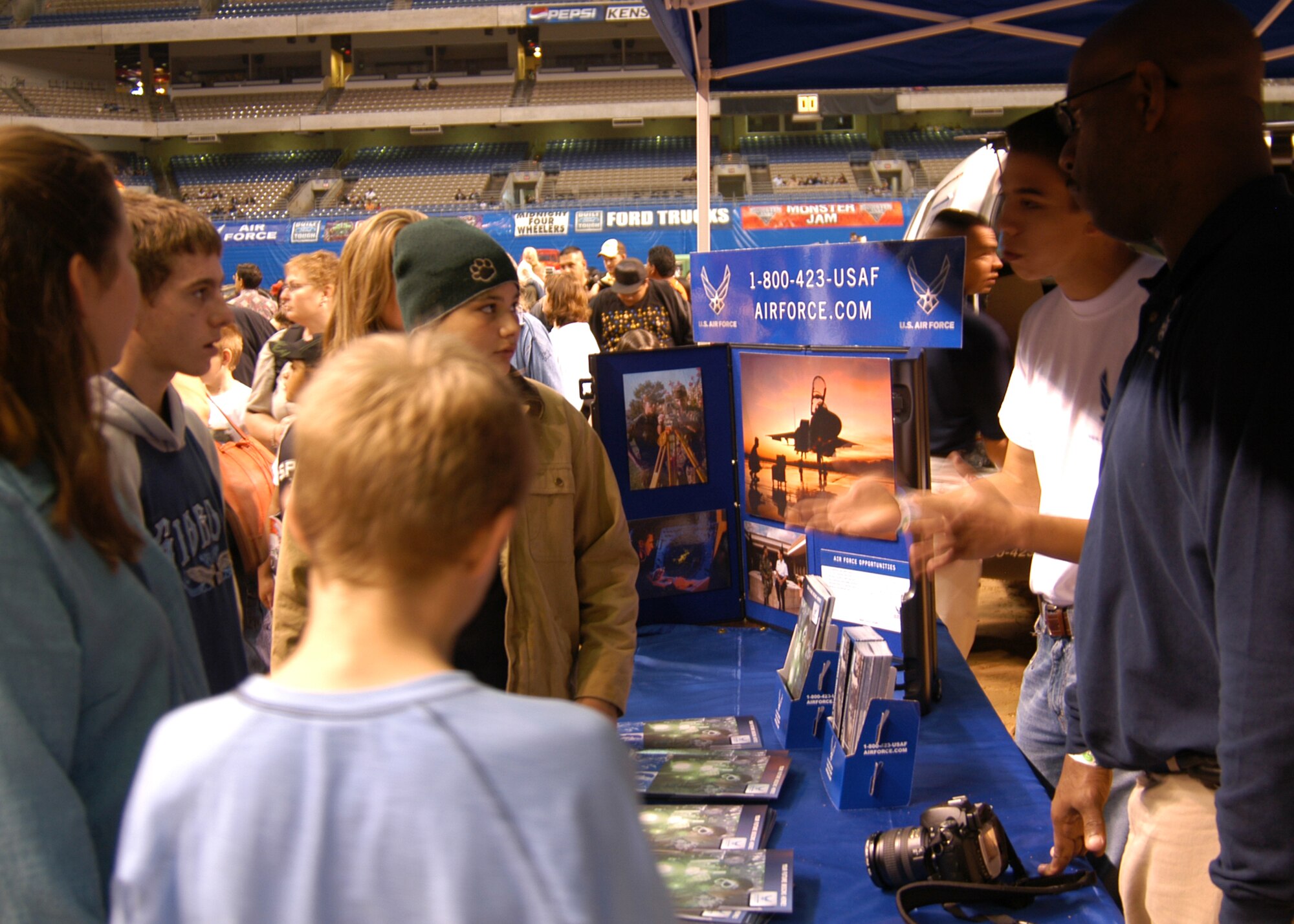 Caleb Cerea, second from right, Air Force Deployed Entry Program member, and Master Sgt. Tony Leverett, 341st Recruiting Squadron B-Flight chief, share career information with Monster Jam fans Tyler Lawrence, 13, center, and Cody Debarge, 15, Jan. 13 in the Alamodome. The two teenagers visited the Air Force recruiting booth for Air Force enlistment information while waiting to meet 2007 monster truck Afterburner driver Damon Bradshaw. (U.S. Air Force photo/Staff Sgt. Jennifer Lindsey)                   