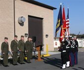 Maj. Daniel M. O'Connor, the Amphibious Reconnaissance School OIC, Lt. Col. Tim Grattan, the MCTAG deputy director, Col. Barton S. Sloat, the U.S. Marine Corps Forces Command G-3 assistant chief of staff, and Col. Stuart L. Dickey, the Expeditionary Warfare Training group, Atlantic commander,  stand at attention during the transfer ceremony from the Amphibious Reconnaissance School Compound to MCTAG Nov. 14 here.