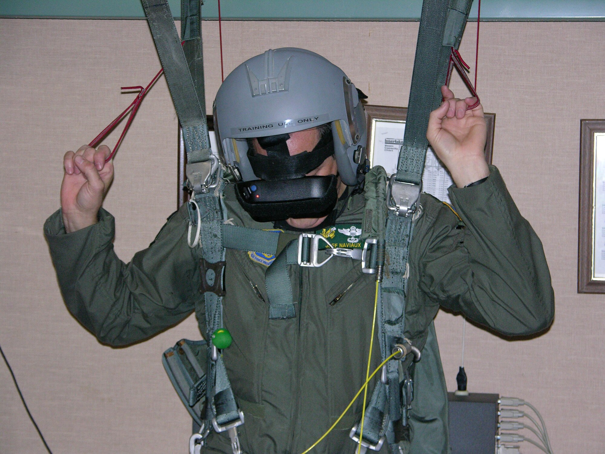 Lt. Col. Jeff Naviaux, commander of the 77th Air Refueling Squadron, goes through harness training. Harness training is a simulated program in which aircrew members practice parachuting out of an aircraft and steering themselves to the ground. Colonel Naviaux is a reservist with the 916th Air Refueling Wing located at Seymour Johnson Air Force Base. (U.S. Air Force Photo by Senior Airman Randy LeMay)          