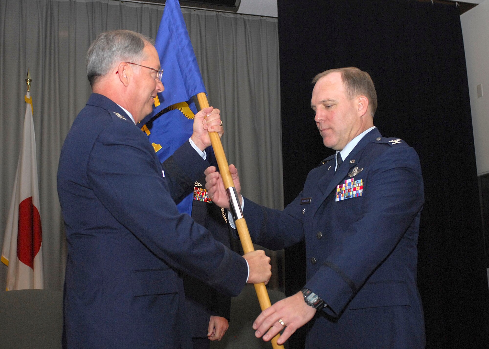 YOKOTA AIR BASE, JAPAN---On January 5, 2007, Detachment 1, 13th Air Force activated at Yokota Air Base, Japan to become the operational arm of Pacific Air Force. Lieutenant General Chip Utterback, 13th Air Force commander, Hickam Air Force Base, Hawaii, takes the flag from the new Detachment 1, 13th Air Force commander, Colonel Michael A. MacWilliam, during activation ceremony. (U.S.Air Force photo by Osakabe Yasuo)