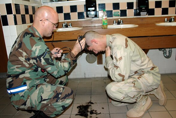 EGLIN AIR FORCE BASE, Fla. – Airman 1st Class Jacob Hoffman, 728th Air Control Squadron surveillance technician, receives a hair cut from Master Sgt. James Pennington, 728th ACS assistant superintendent of operations prior to deploying to Southwest Asia in support of Operation Iraqi Freedom Jan. 15. (Air Force photo/by Staff Sgt. Phillip O. Butterfield)

 

