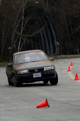 A student attempts to manuever a sedan through a slalom obstacle at the Anti-terrorism Driving Course here Jan. 5. Photo by Senior Airman Megan Carrico.