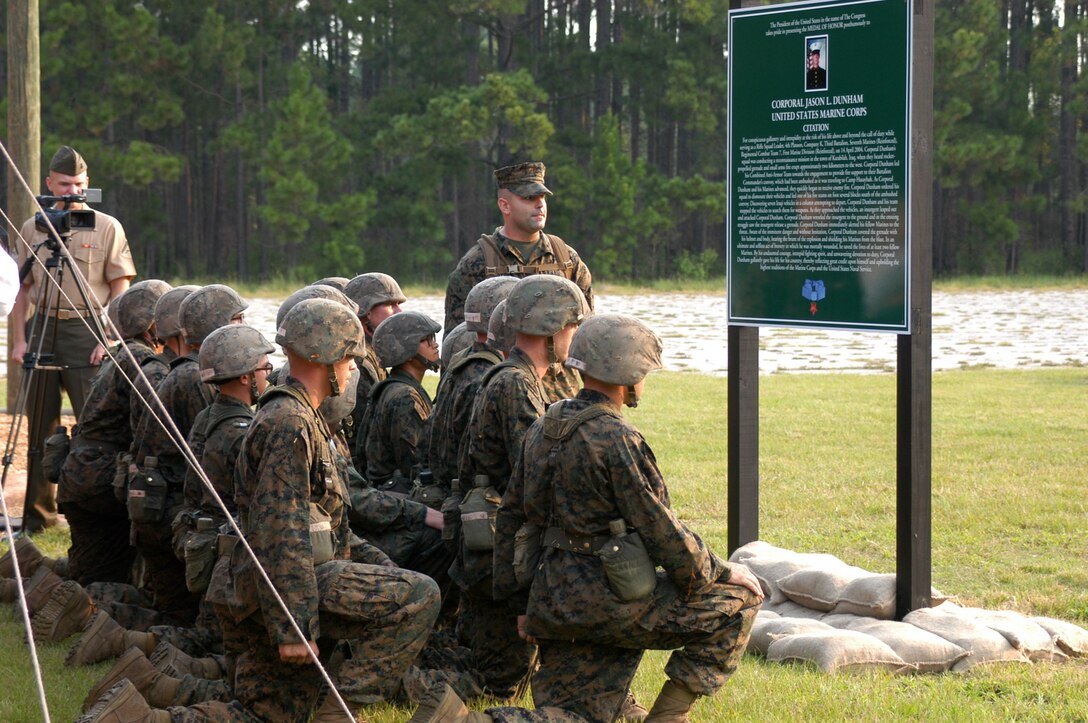 Staff Sgt. Anthony Merchant a drill instructor with Platoon 3064, Kilo Company, 3rd Recruit Training Battalion, reads Cpl. Jason Dunham's Medal of Honor citation to his recruits, after the warrior's station Dunham's Defense dedication ceremony Aug. 16 aboard Parris Island. At Dunham's Defense, recruits will read Dunham's Medal of Honor citation, and then perform ground-fighting techniques taught throughout the Marine Corps Martial Arts Program. These techniques will reflect those Dunham used to defend himself and his fellow Marines on the day which led to his nomination for the Medal of Honor.