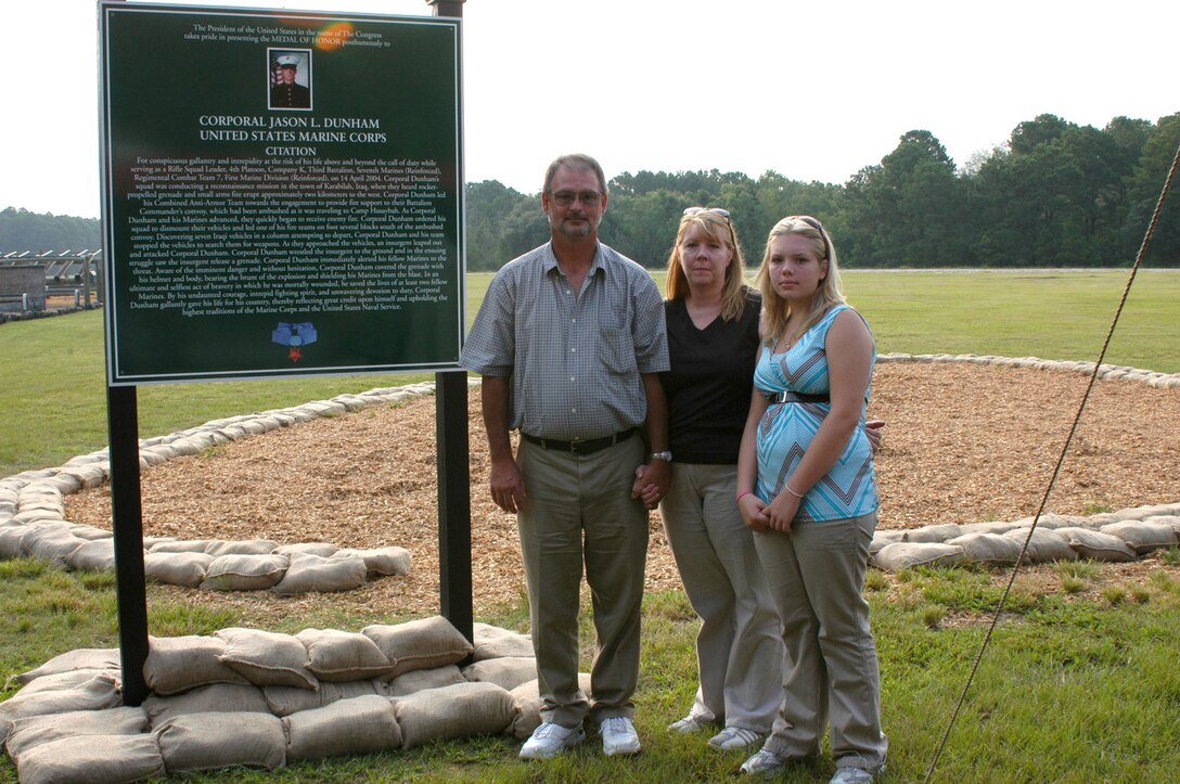 Dan, Deb and Katie Dunham, the parents and younger sister of Cpl. Jason Dunham, who was posthumously awarded the Medal of Honor, stand next to the Crucible warrior's station Dunham's Defense after the dedication ceremony held Aug. 16 aboard Parris Island.