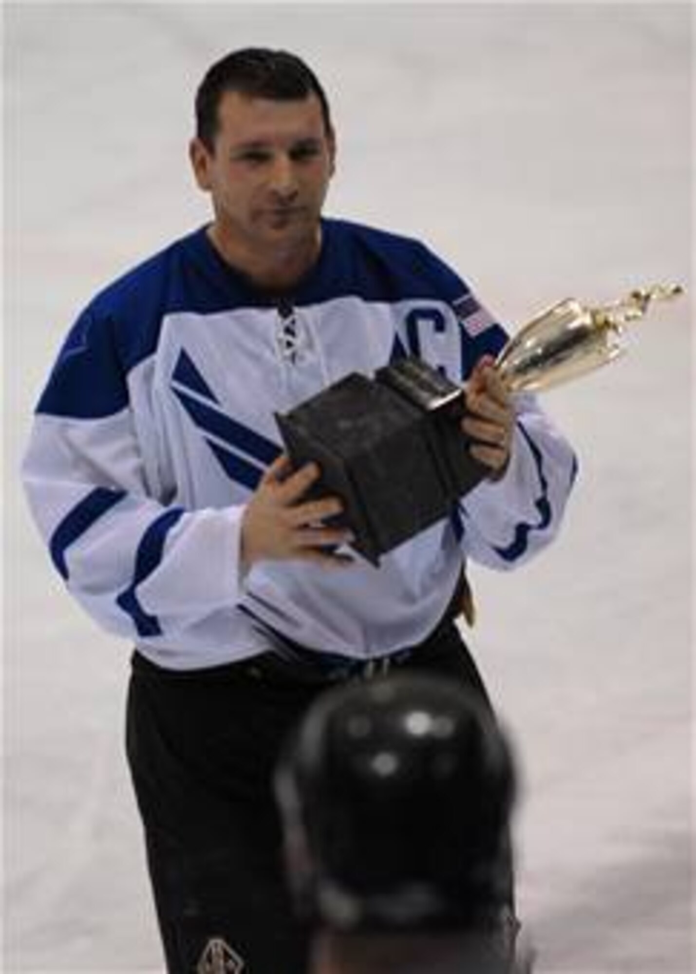 EIELSON AIR FORCE BASE, Alaska -- Senior Master Sgt. Dan Morin, 354 Fighter Wing, 354 Maintenance Squadron, holds the Trophy for the Commander's Cup Hockey Game on Jan. 13. Eielson ICEMEN faced off against Fort Wainwright Grizzlies in the 11th Annual Interior Alaska Armed Forces Ice Hockey Commander's Cup Game. Eielson went on to win the game 8 to 6. (US Air Force Photo by Airman Jonathan Snyder)
