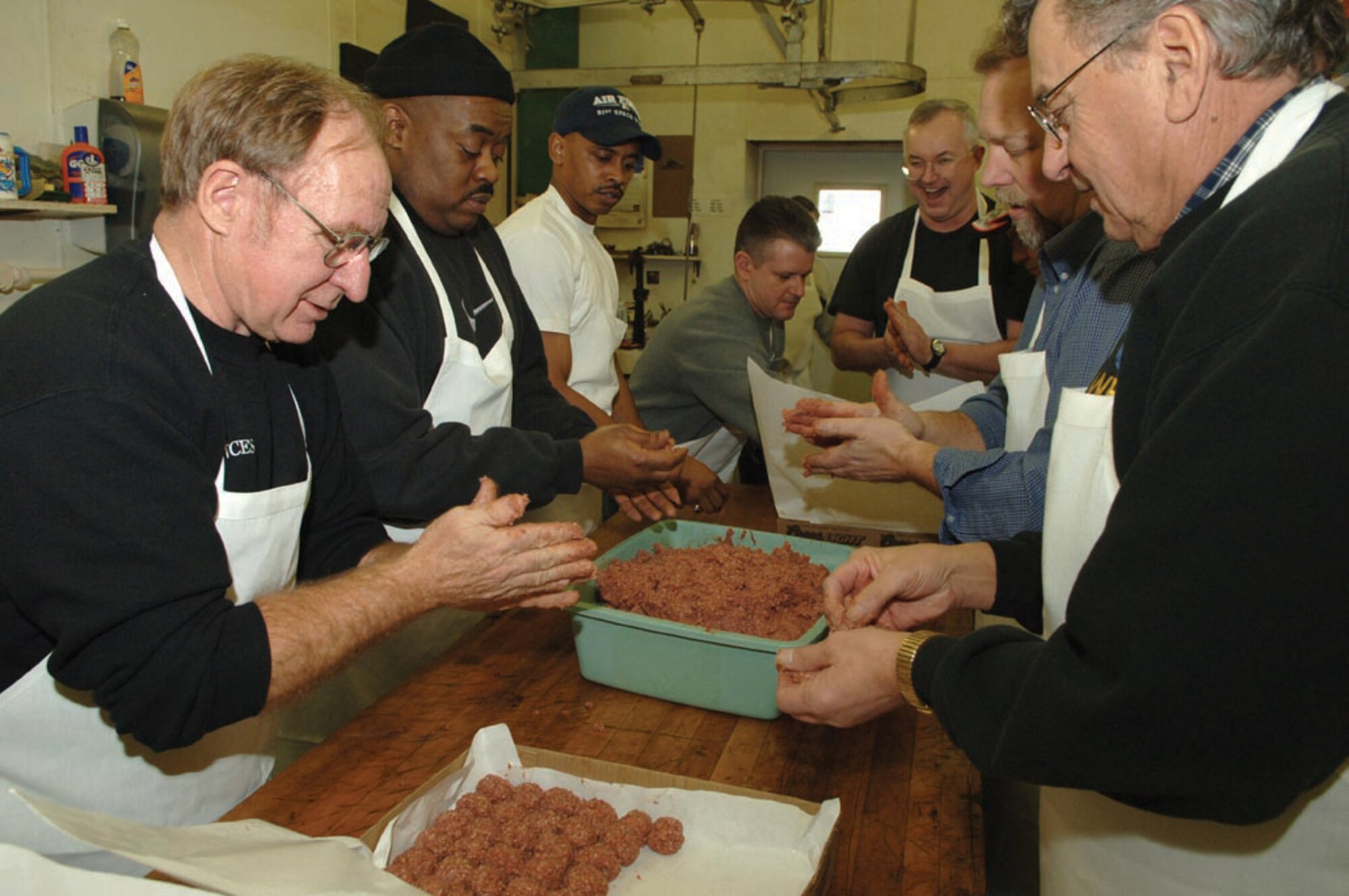 MINOT AIR FORCE BASE, N.D. -- A group of Team Minot members roll meatballs Jan. 20, 2006 at Bloms’ Locker and Processing Plant in Minot, N.D., during the meat-cutting for the 41st annual Sportsmen’s Feed, an annual gathering of food (various types of game like duck, pheasant and venison), friendship and football-watching. The 42nd annual Sportsmen’s Feed starts at noon Jan. 21, 2007 at the Jimmy Doolittle Center. Price of a ticket is $30 and, in addition to the purchaser, each ticket sold entitles a selected Airman to free admission. To purchase tickets, contact unit first sergeants or group superintendents. (U.S. Air Force photo by Staff Sgt. Jocelyn Rich)