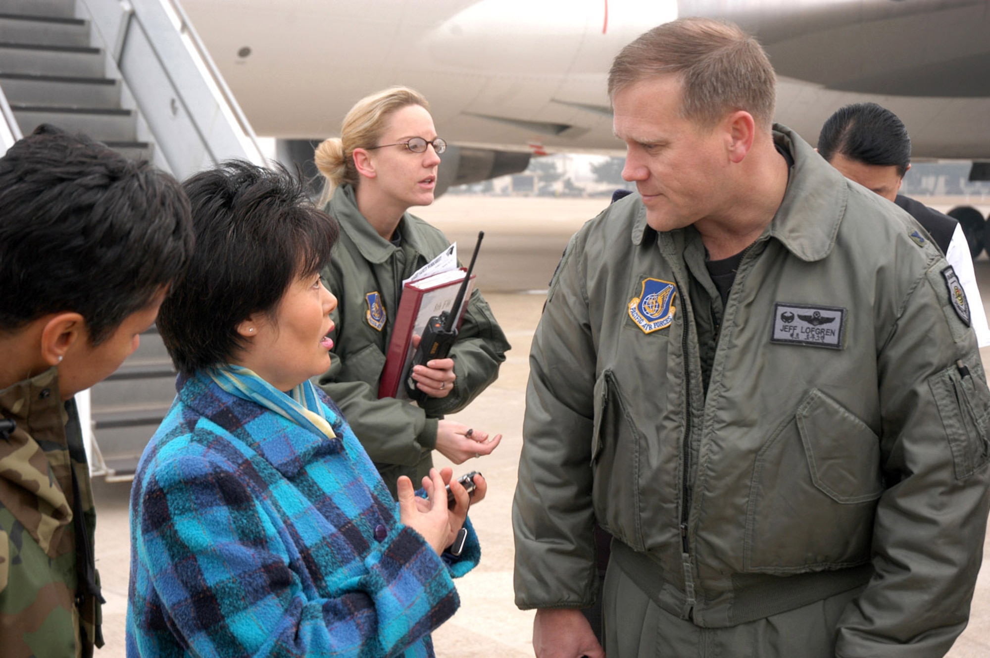 Col. Jeff Lofgren, 8th Fighter Wing commander, talks with airfield operations personnel after two Korean Airline 747s diverted to Kunsan Air Base, South Korea, from Incheon International Airport because of foggy weather conditions. Medical and security personnel also responded to the aircraft. (U.S. Air Force photo/Staff Sgt. Nathan Gallahan) 