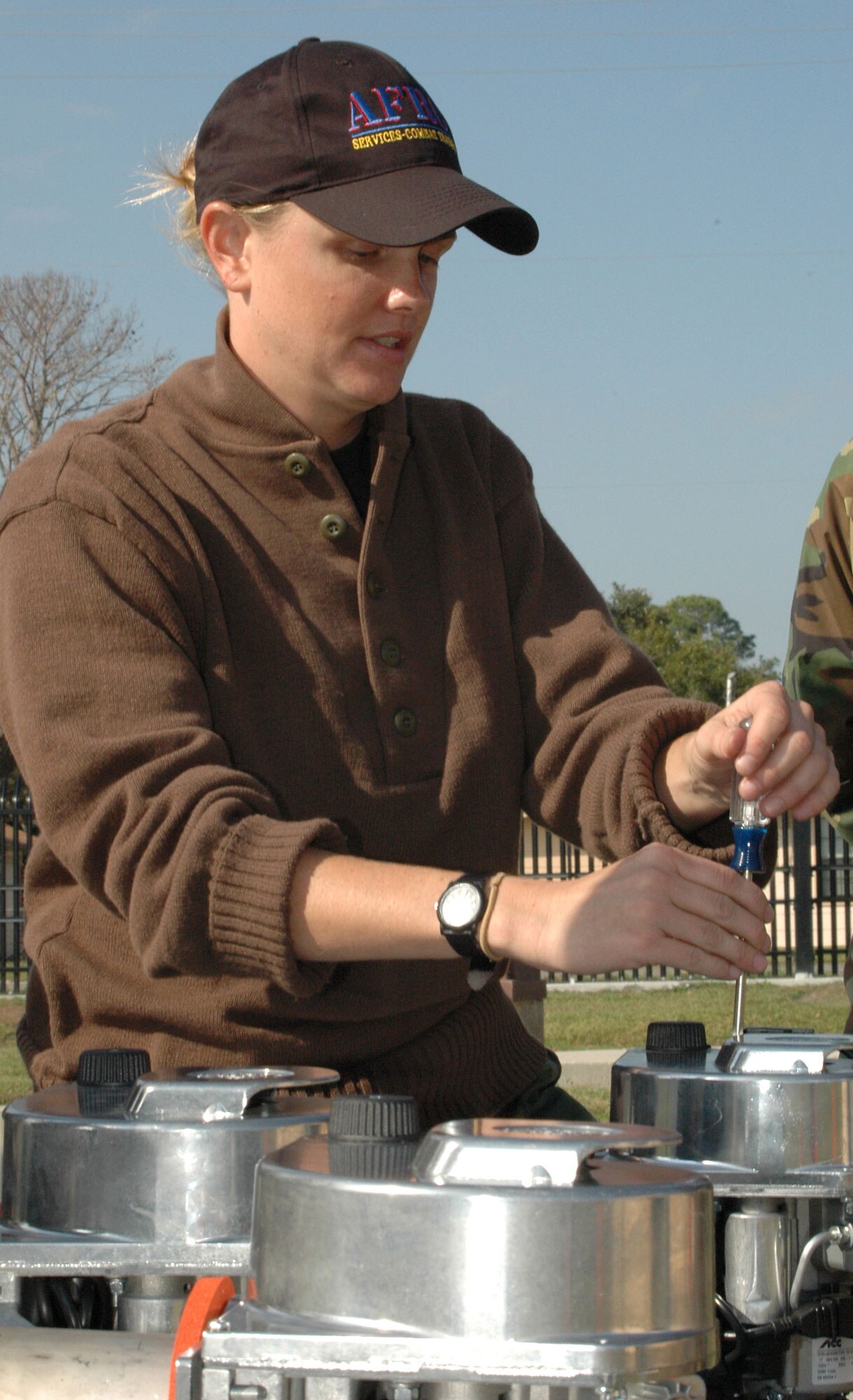 Tech. Sgt. Kelly Kruger, a services combat instructor, demonstrates procedures used in troubleshooting a Babington Burner. Sergeant Kruger and others from her team at Dobbins ARB, Ga. travel to different AFRC units to help them learn more abou the new Single Pallet Expeditionary Kitchen and its new equipment. (U.S. Air Force Photo By Airman 1st Class Tabitha Spinks)