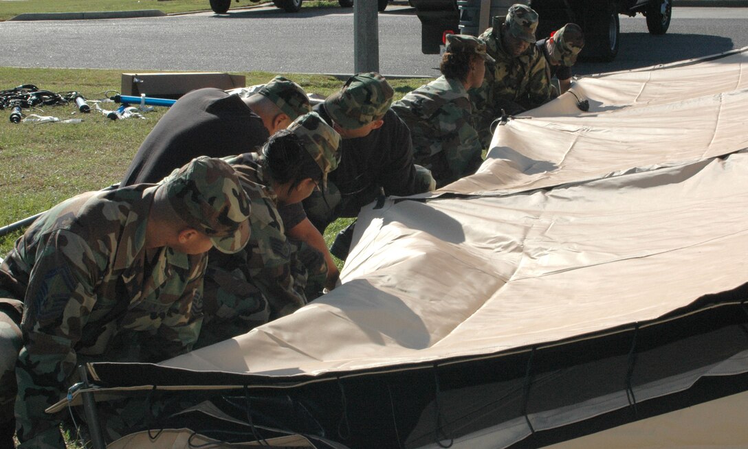 A team from the 403rd Services Flight "Prime Beef," sets up the tent for the Single Palette Expeditionary Kitchen. The SPEK is the new, highly-mobile deployable kitchen. Part of the flight trained on setting up the SPEK in September 2006 at Dobbins Air Reserve Base, Ga. (U.S. Air Force Photo By Airman 1st Class Tabitha Spinks)