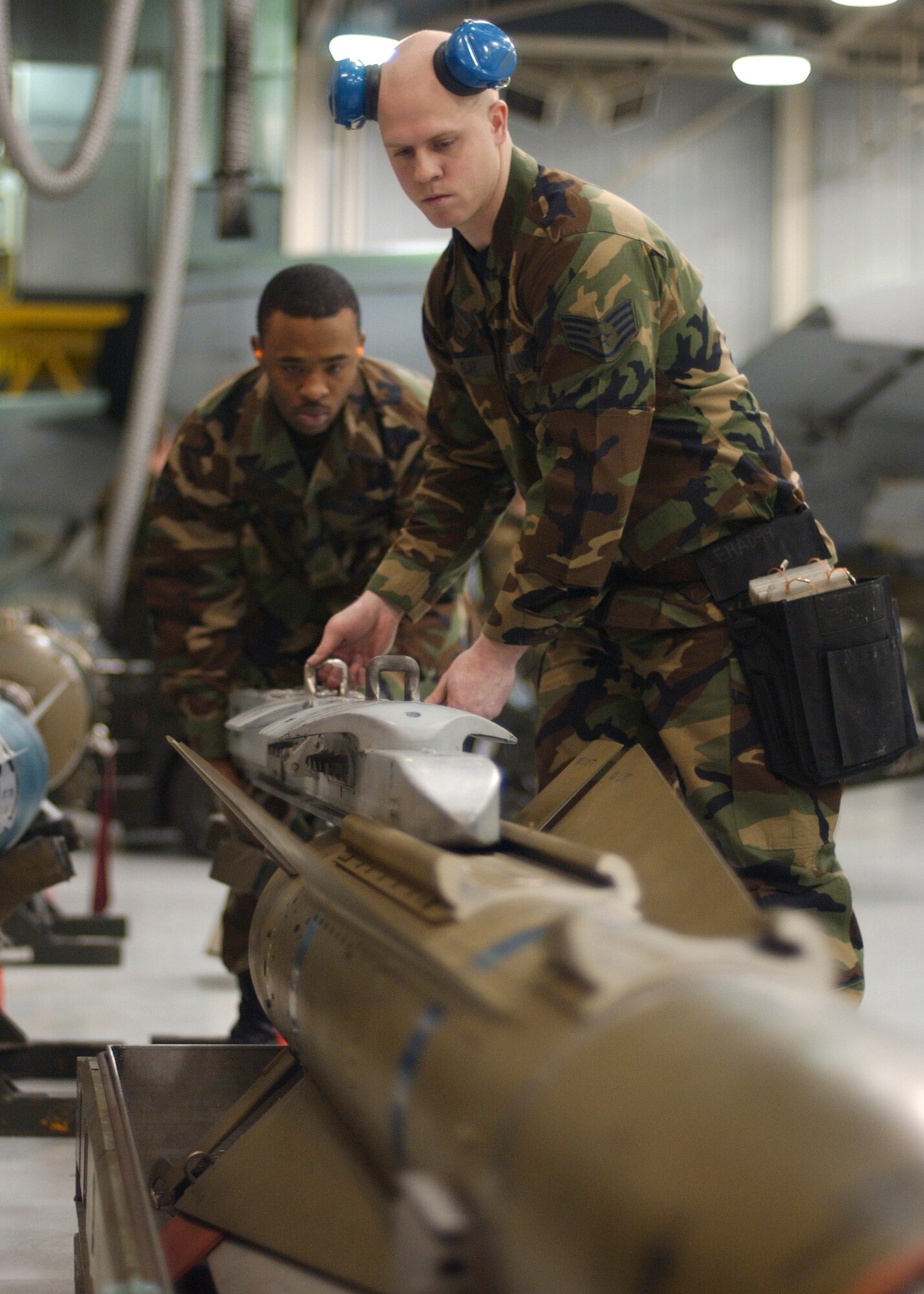 EIELSON AIR FORCE BASE, Alaska -- Staff Sgt. Aaron Slay (right) and Senior Airman Corneilius Cutler, 18th Aircraft Maintenance Unit, 354th Aircraft Maintenance Squadron slides a LAU-117 into place on top the Air to Ground Missile 65 D Bomb to be loaded onto an F-16 Fighting Falcon during the Weapons Standardization Load Crew of the Year Competition here on Jan. 11. The Competition evaluates technical proficiency, safety procedures and overall time. The 18th AMU's overall time was 56 minutes and 37 seconds.  
(US Air Force Photo by Airman Jonathan Snyder)