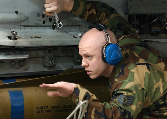 EIELSON AIR FORCE BASE, Alaska -- Staff Sgt. Aaron Slay, 18th Aircraft Maintenance Unit, 354th Aircraft Maintenance Squadron motions to position the Air to Ground Missile 65 D Bomb to be loaded onto an F-16 Fighting Falcon for the Weapons Standardization Load Crew of the Year Competition here on Jan. 11. The Competition evaluates technical proficiency, safety procedures and overall time. The 18th AMU's overall time was 56 minutes and 37 seconds.  
(US Air Force Photo by Airman Jonathan Snyder)