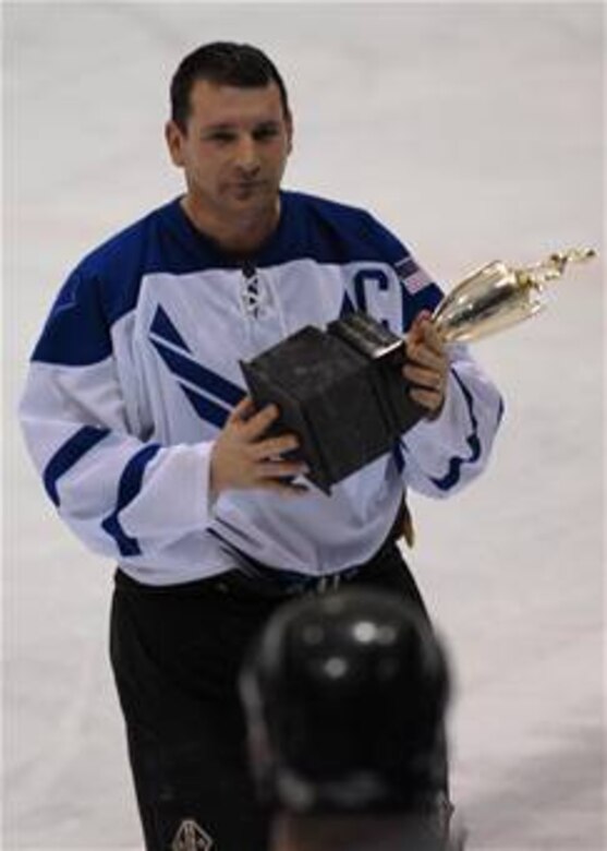 EIELSON AIR FORCE BASE, Alaska --  Senior Master Sgt.  Dan Morin, 354 Fighter Wing, 354 Maintenance Squadron, holds the Trophy for the Commander's Cup Hockey Game on Jan. 13. Eielson ICEMEN faced off against Fort Wainwright Grizzlies in the 11th Annual Interior Alaska Armed Forces Ice Hockey Commander's Cup Game. Eielson went on to win the game 8 to 6. 
(US Air Force Photo by Airman Jonathan Snyder)