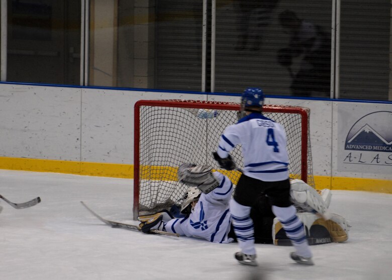 EIELSON AIR FORCE BASE, Alaska -- Mr. Chris Schaffer blocks the puck from going into the goal at the Big Dipper Ice Arena, Fairbanks on Jan. 13. Eielson ICEMEN faced off against Fort Wainwright Grizzlies in the 11th Annual Interior Alaska Armed Forces Ice Hockey Commander's Cup Game. Eielson went on to win the game 8 to 6. 
(US Air Force Photo by Airman Jonathan Snyder)