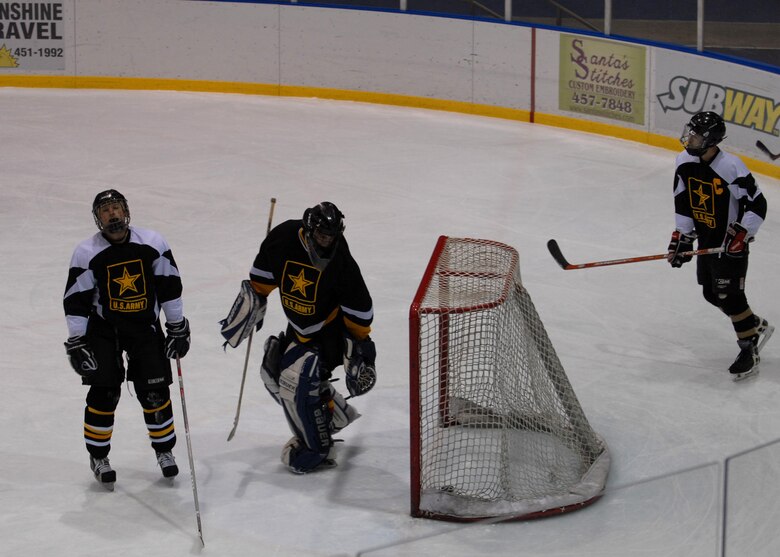 EIELSON AIR FORCE BASE, Alaska -- Eielson ICEMEN score on Fort Wainwright Grizzlies at the Big Dipper Ice Arena, Fairbanks on Jan. 13. Eielson ICEMEN faced off against Fort Wainwright Grizzlies in the 11th Annual Interior Alaska Armed Forces Ice Hockey Commander's Cup Game. Eielson went on to win the game 8 to 6.  
(US Air Force Photo by Airman Jonathan Snyder)