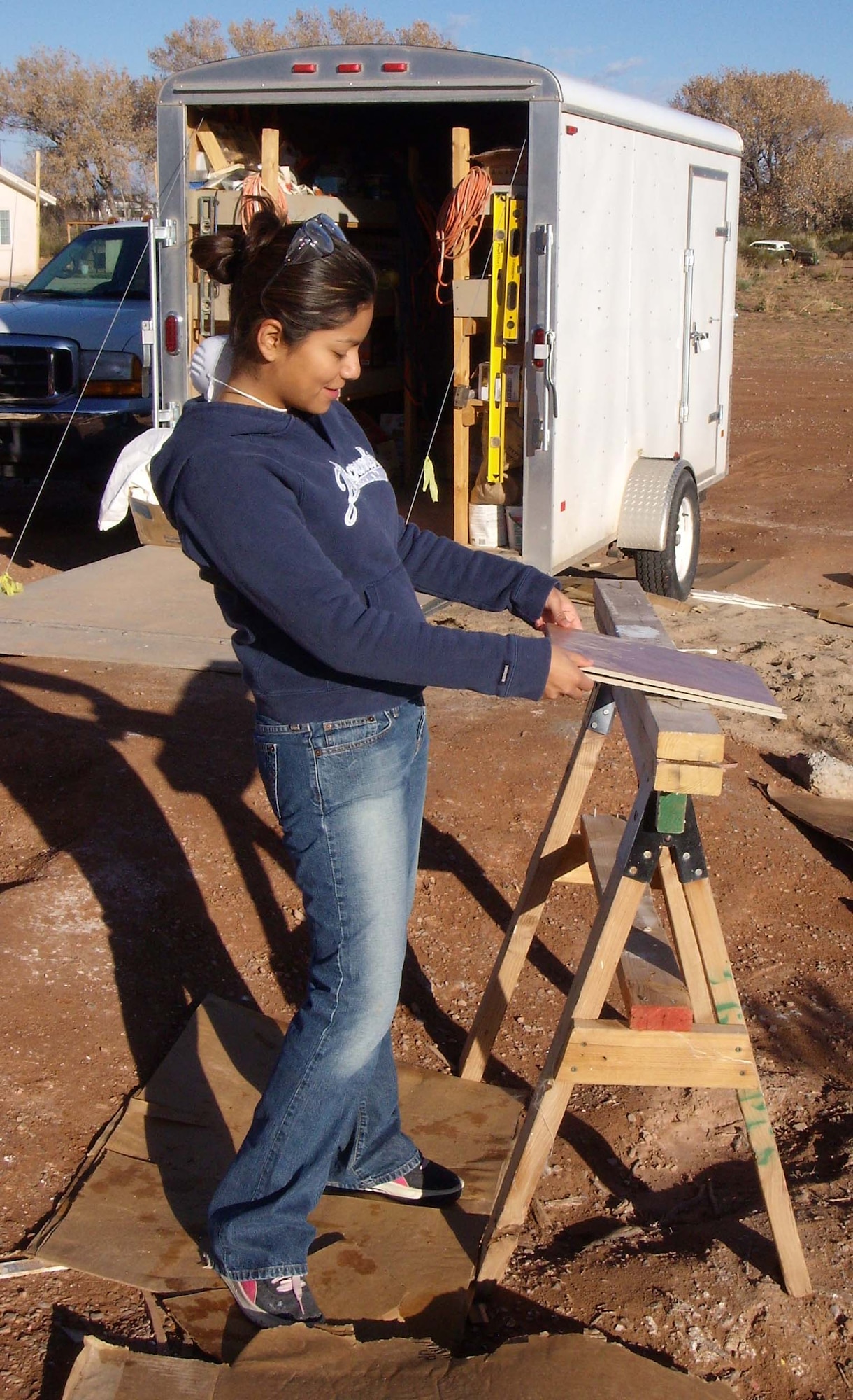 1st Lt. Sandra Martinez, 49th Comptroller Squadron, readies a tile before it's installed into a home the CGOC is helping build with Habitat for Humanity. The home is in Tularosa and is scheduled to be completed by the end of February. 