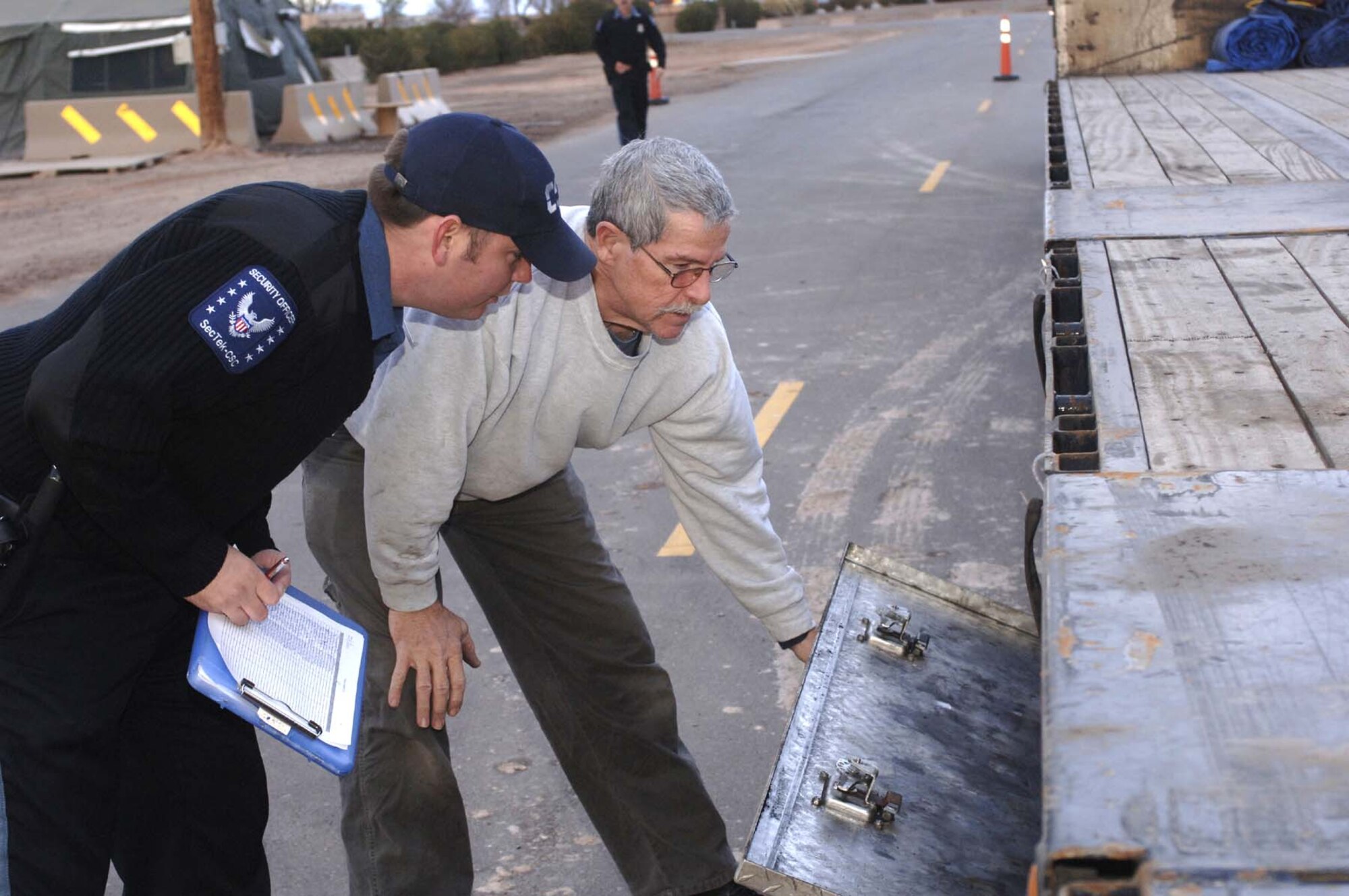 Mr. Roby McCool, Holloman gate guard, inspects Mr. Douglas Magneson's truck for entrance to Holloman. (U.S. Air Force phot by Staff Sgt. Jason Colbert)