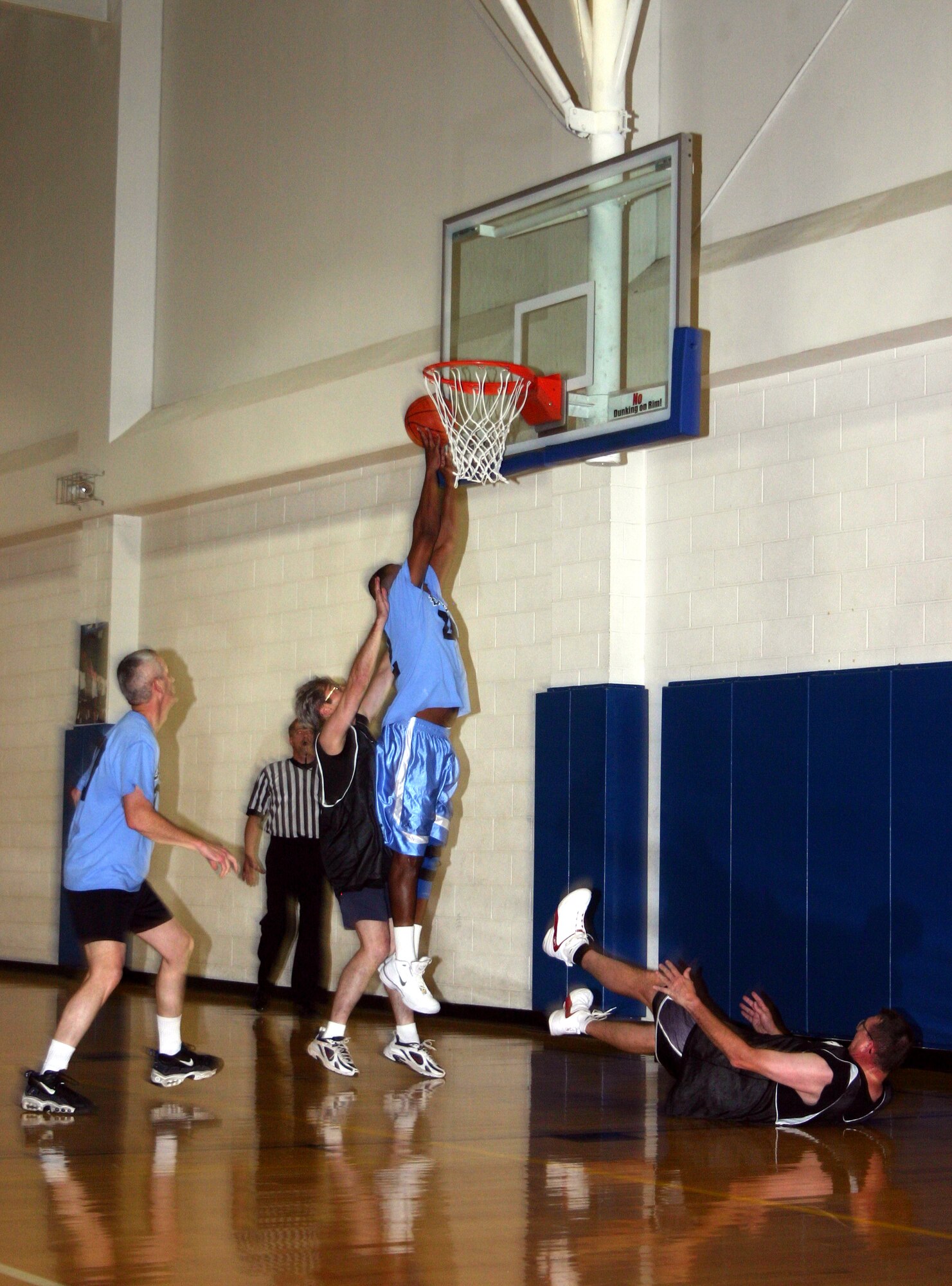 Sam Lofton, 82nd Training Group commander, smashes past the Chiefs defense to make a layup during the Chiefs vs. Eagles game Jan. 12 at the Pitsenbarger Fitness Center. (U.S. Air Force photo/Airman 1st Class Jacob Corbin.)