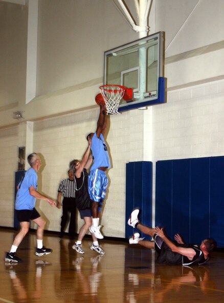 Sam Lofton, 82nd Training Group commander, smashes past the Chiefs defense to make a layup during the Chiefs vs. Eagles game Jan. 12 at the Pitsenbarger Fitness Center. (U.S. Air Force photo/Airman 1st Class Jacob Corbin.)