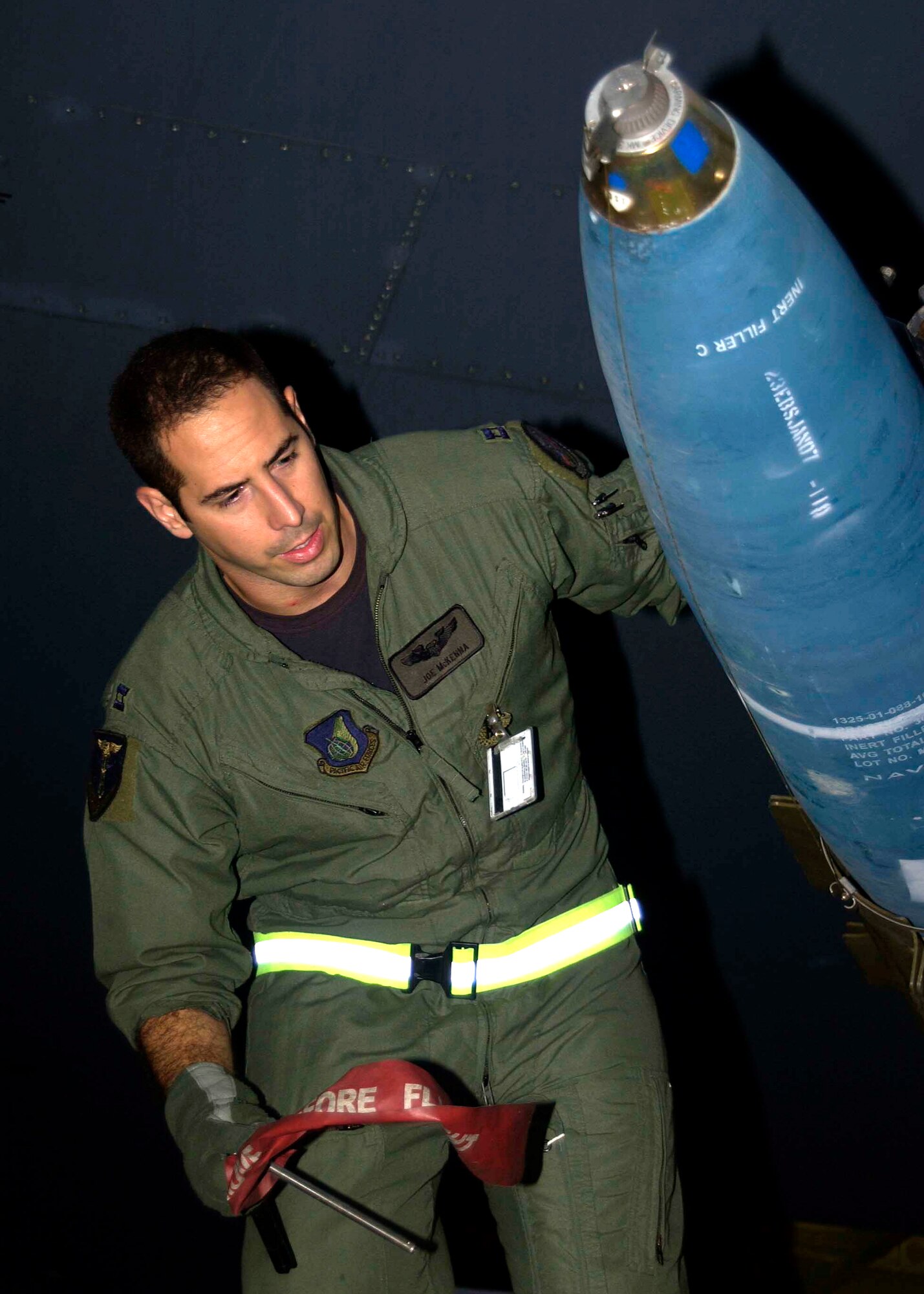 Capt. Joseph McKenna, a B-52 Stratofortress radar navigator assigned to the 23rd Expeditionary Bomb Squadron, checks a Mk-62 "Quickstrike" inert aerial mine prior to takeoff on a counter-sea exercise mission. The 23rd EBS completed a five-day counter-sea exercise Jan. 19, dropping 100 inert mines into the Pacific Ocean over the Marianas Trench. (U.S. Air Force Photo/Senior Master Sgt. Don Perrien)
