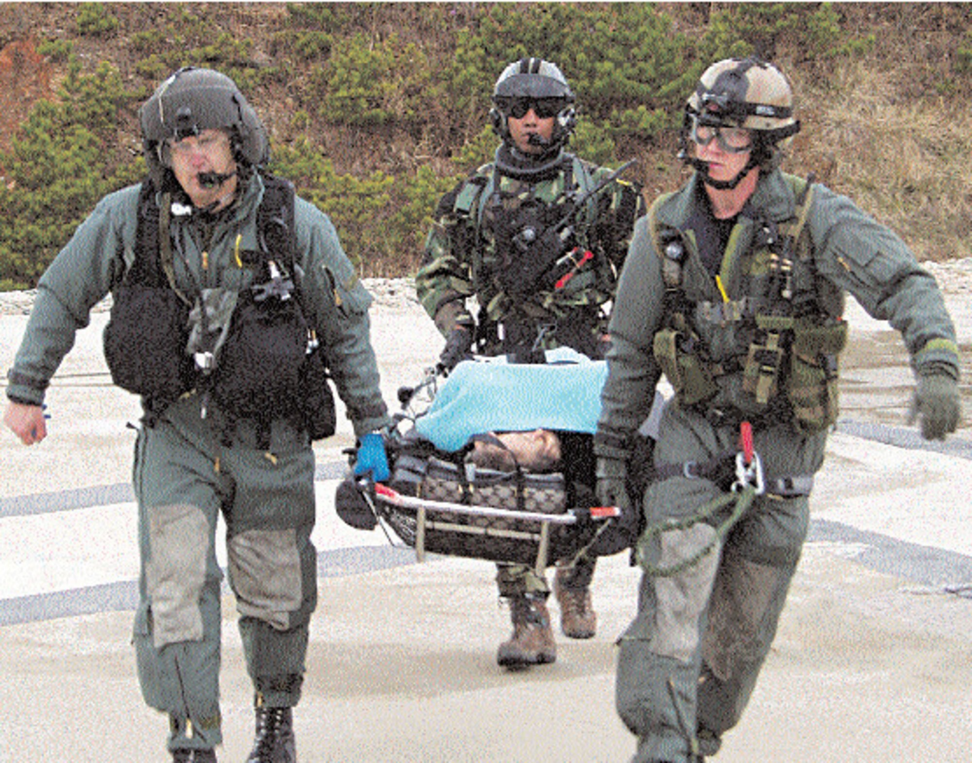 OSAN AIR BASE, Republic of Korea --  From left: Lt. Col. Lee Harvis, 51st Aeromedical-Dental Squadron flight surgeon, Staff Sgt. Bembry King, 33rd Rescue Squadron pararescue team leader, and Senior Airman Kristofer Darrow, 33rd RQS pararescue team member, carry a patient to the HH-60 for medical evacuation. (Courtesy photo)