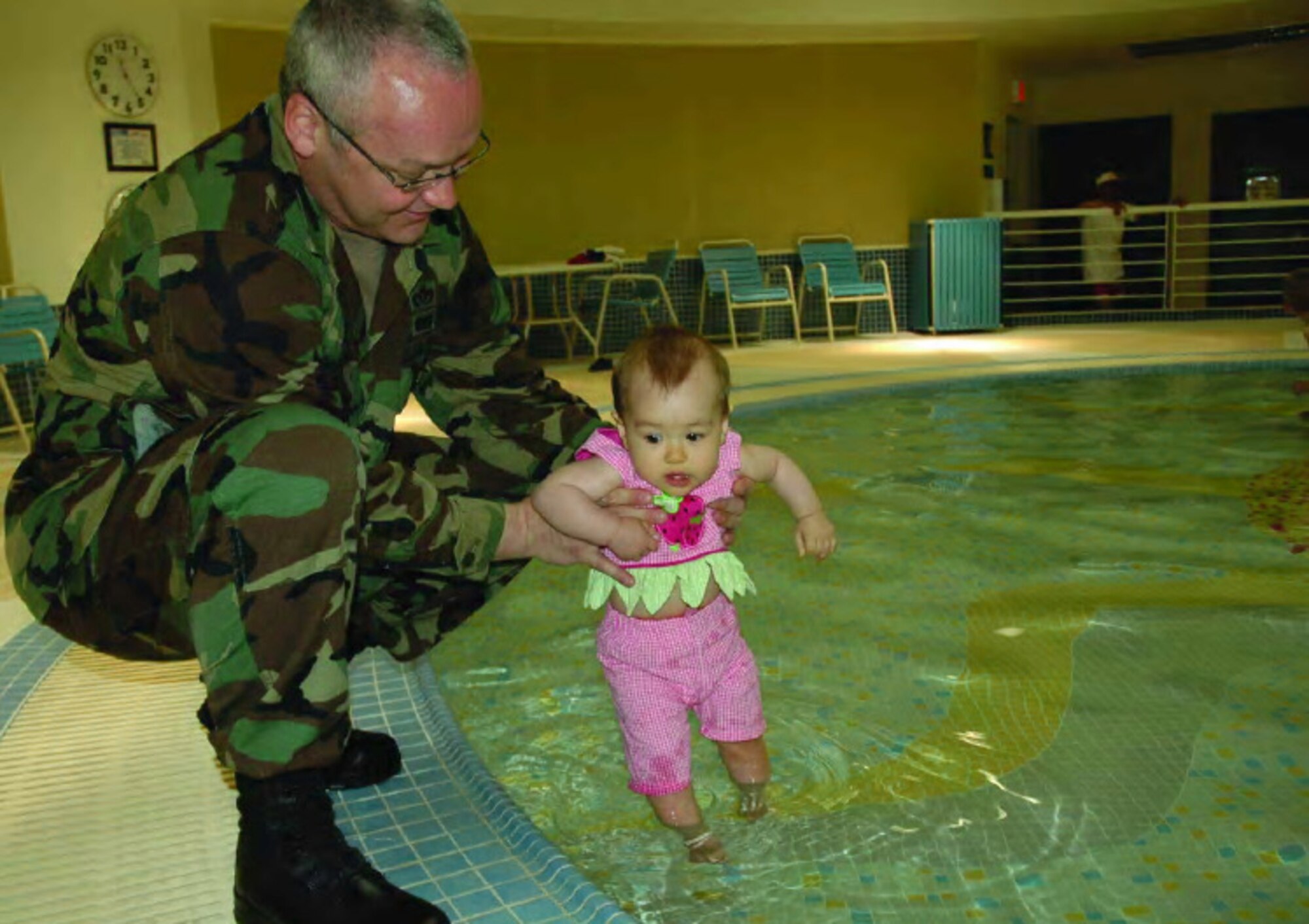 OSAN AIR BASE, Republic of Korea --  Col. Shane Stegman, 51st Mission Support Group deputy commander, and daughter Ellie, 9 months, were the first people to take a dip in Osan's new indoor wading pool May 22. (U.S. Air Force photo by Staff Sgt. Andrea Knudson)