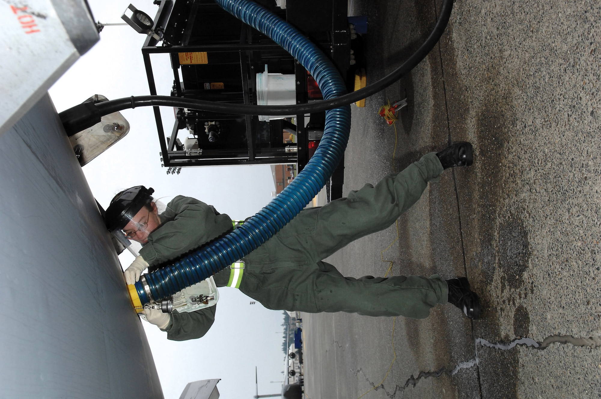 MCCHORD AIR FORCE BASE, Wash.-- 
Senior Airman Elizabeth Sparks, 62nd Aerial Port Squadron, mounts a hose attached to a lavatory service truck on the flightline to remove Kryotec from a C-17 Globemaster III.
(U.S. Air Force photo/Abner Guzman)