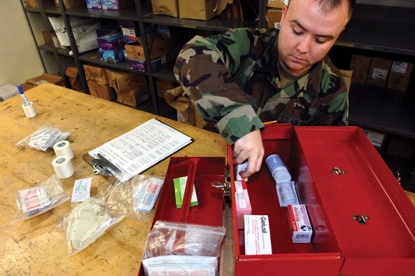MCCHORD AIR FORCE BASE, Wash.-- 
Airman 1st Class Brantley Day, 62nd Aerial Port Squadron, uses a checklist in Bldg. 1419 to ensure first aid kits are complete prior to being transported to various aircraft.
(U.S. Air Force photo/Abner Guzman)