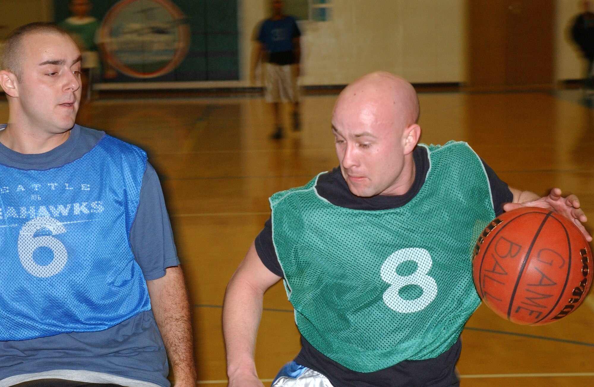 MCCHORD AIR FORCE BASE, Wash.-- 
Cyle Grieve, 62nd Logistics Readiness Squadron, drives to the basket while James Schwertman, 8th Airlift Squadron, defends.
(U.S. Air Force photo/Tyler Hemstreet)
