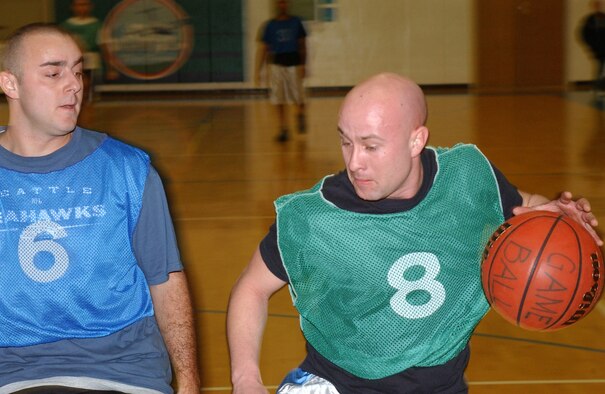 MCCHORD AIR FORCE BASE, Wash.-- 
Cyle Grieve, 62nd Logistics Readiness Squadron, drives to the basket while James Schwertman, 8th Airlift Squadron, defends.
(U.S. Air Force photo/Tyler Hemstreet)