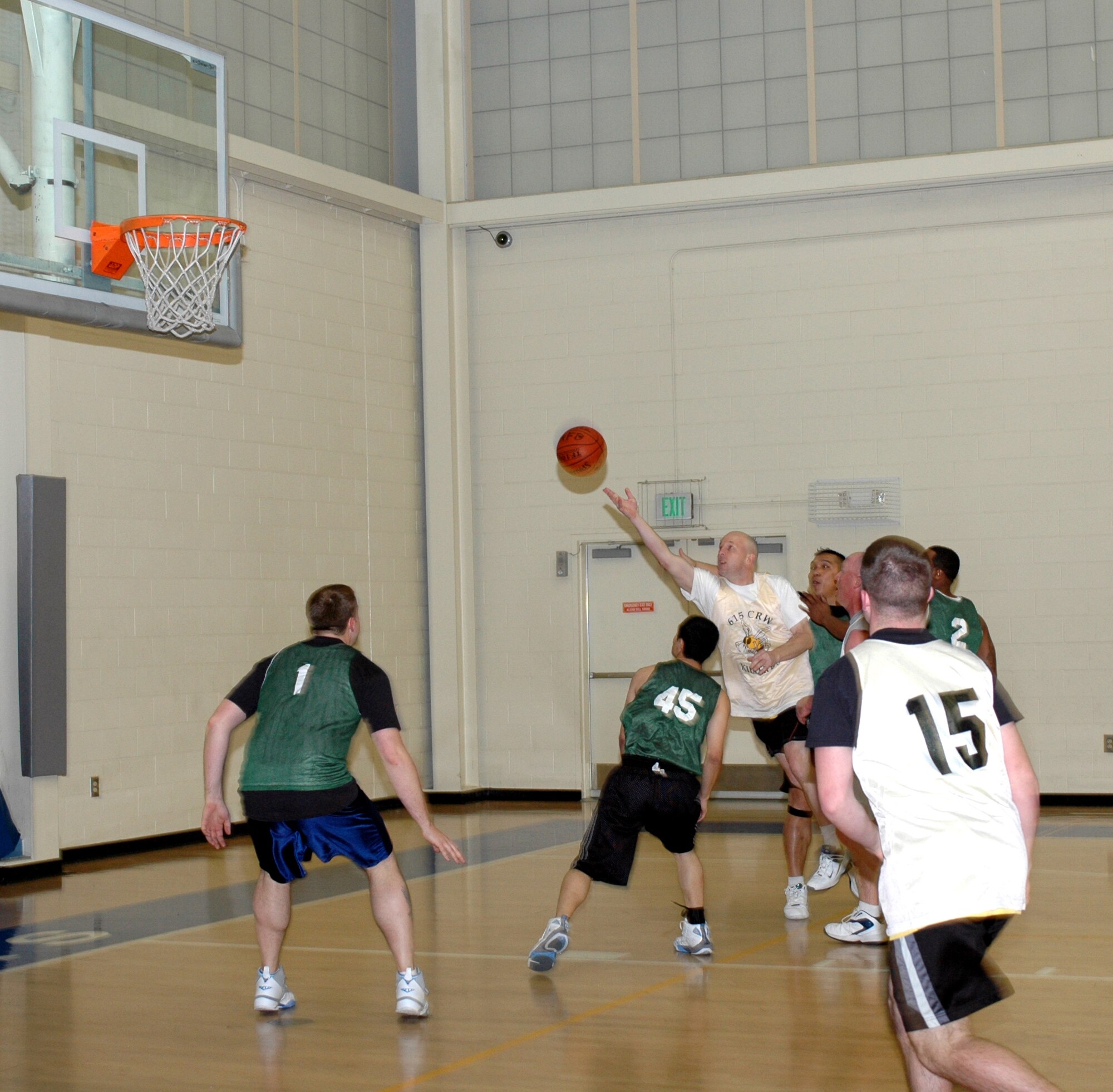 Leif Larson, (white jersey), Killer B's small forward, gets off an acrobatic layup during his team's 32-29 lost to the Log Dawgs Jan. 16. Larson was his team's leading scorer with six points. (U.S. Air Force photo by Staff Sgt. Candy Knight)