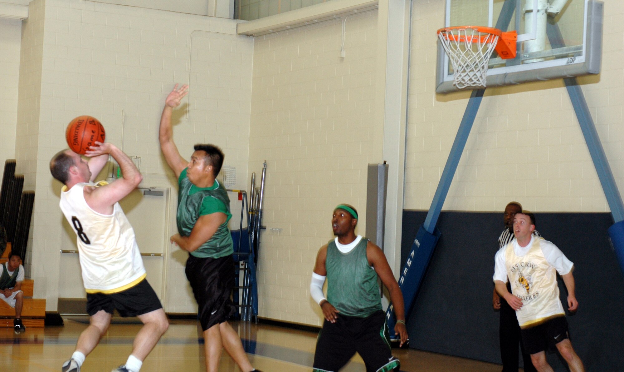 Casey Tharp, (#8), Killer B's point guard, shoots a fade-away jumper during his team 32-29 lost to the Log Dawgs Jan. 16. Tharp was his team second leading scorer with five points. (U.S. Air Force photo by Staff Sgt. Candy Knight)