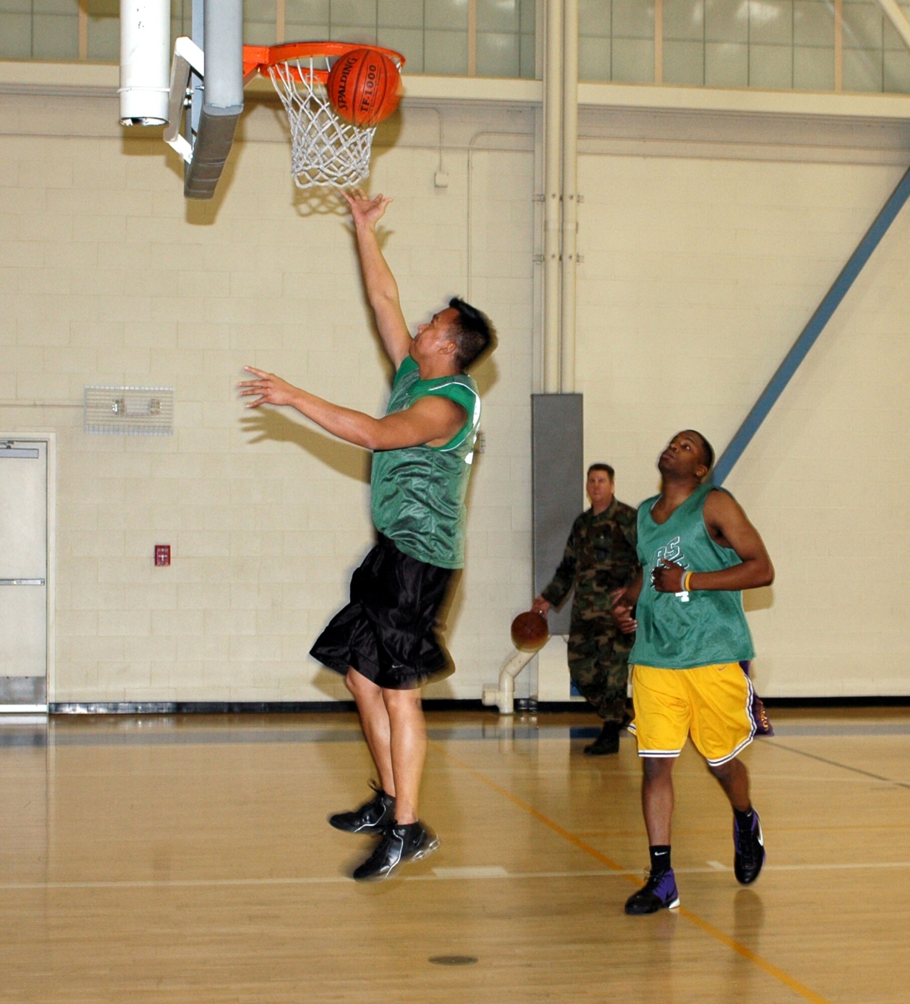 Cecilio Rondolos, Log Dawgs shooting guard, hits a layup as teammate Chris Williams looks on. The Log Dawgs defeated the Killer B's 32-29 Jan. 16. (U.S. Air Force photo by Staff Sgt. Candy Knight)