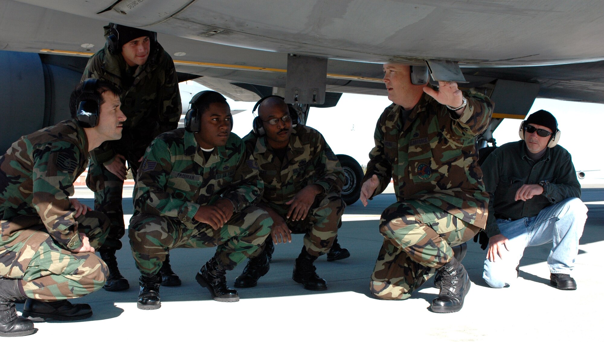 Tech. Sgt. Kevin Harding (second from the right)  discusses what happens if a KC-10 Extender No. 1 engine's drain mast is not properly serviced with KC-10 training course students Jan. 17 at Travis Air Force Base, Calif. Sergeant Harding is assigned to the 60th Maintenance Operations Squadron at Travis AFB. Currently six Airmen from Hickam AFB, Hawaii and Kadena Air Base, Japan, are taking the two-phase course designed to train enroute maintainers how to recover and perform basic maintenance tasks and help move the aircraft through the theatre more efficiently. (U.S. Air Force photo/Staff Sgt. Candy Knight) 