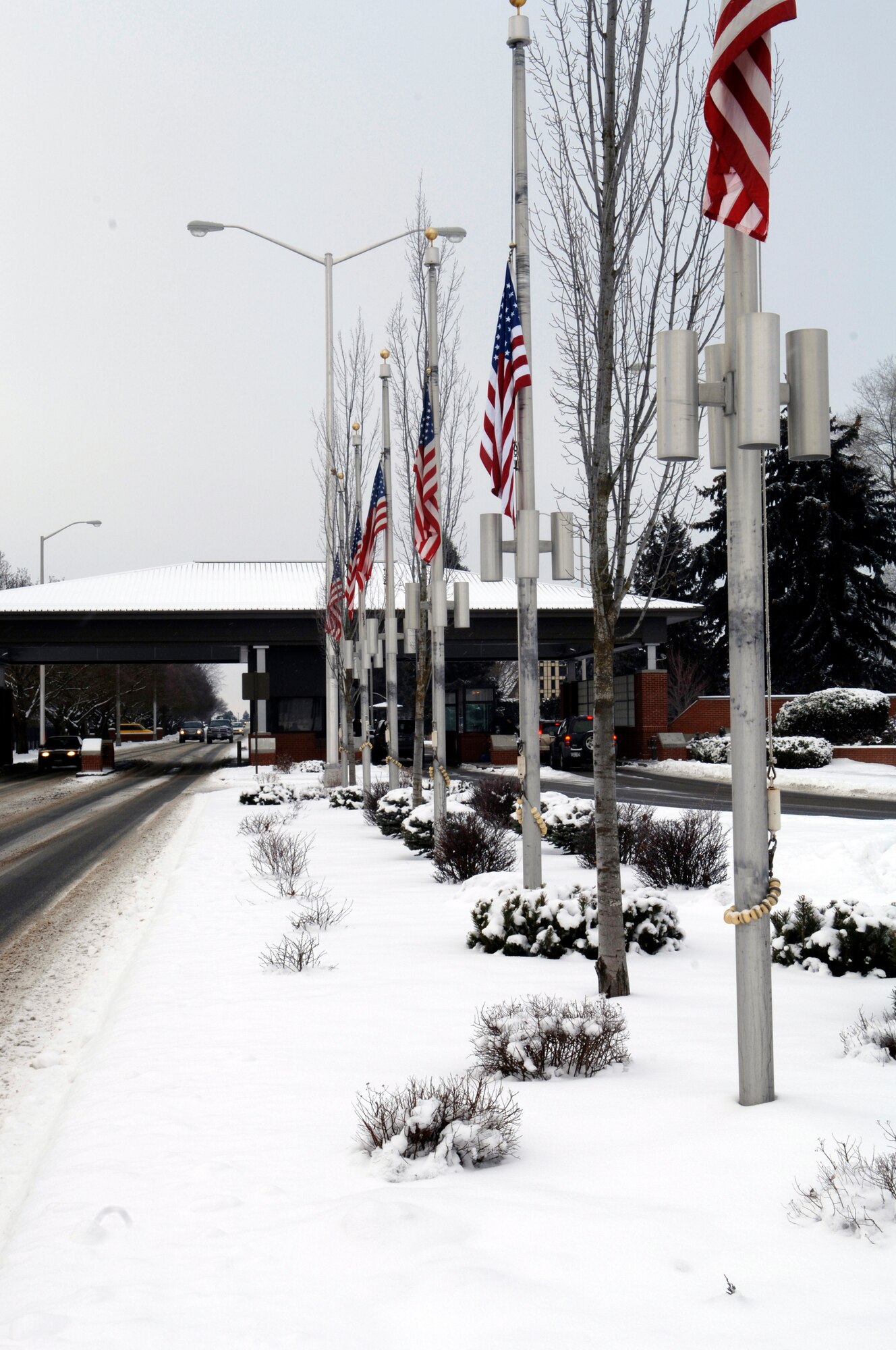 American flags offer a warm welcome and farewell as people enter and exit the base. Over the past week, Fairchild has received a layer of snow that has blanketed the entire base in white.