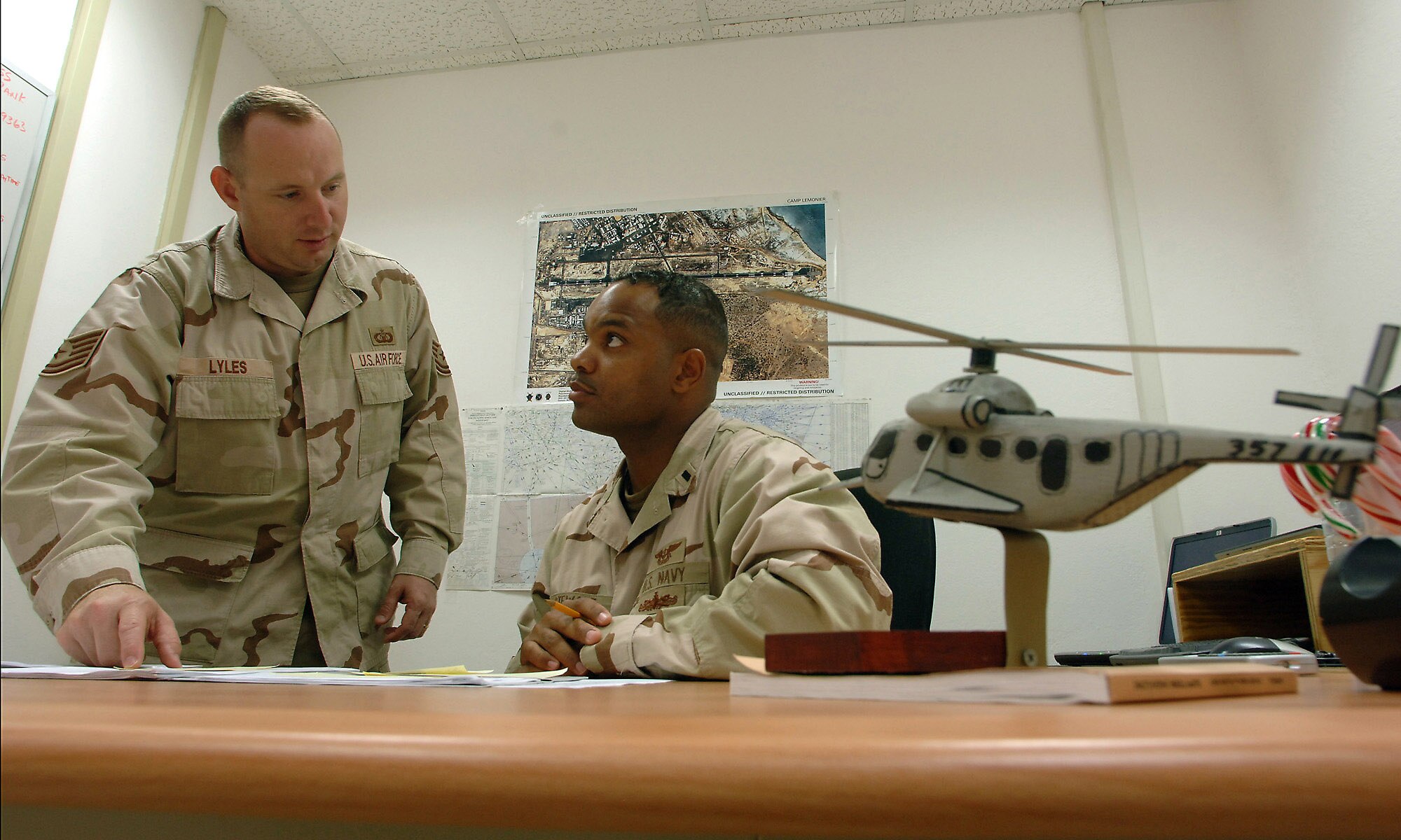 Navy Lt. j.g. Stewart Arthur and Tech. Sgt. Brian Lyles manage 10 Air Force and Navy servicemembers who partner with Djiboutian civilians and French military in guiding all aircraft flying in and out of the airfield shared by Camp Lemonier and the Djibouti-Ambouli airport. They are the enlisted and commissioned air traffic and early warning control officers assigned to Combined Joint Task Force-Horn of Africa headquarters at Camp Lemonier, Djibouti. Lieutenant Arthur is deployed from Naval Air Station North Island, San Diego, Calif., and Sergeant Lyles is deployed from Royal Air Force Mildenhall, England. (U.S. Air Force photo/Master Sgt. Scott Wagers)