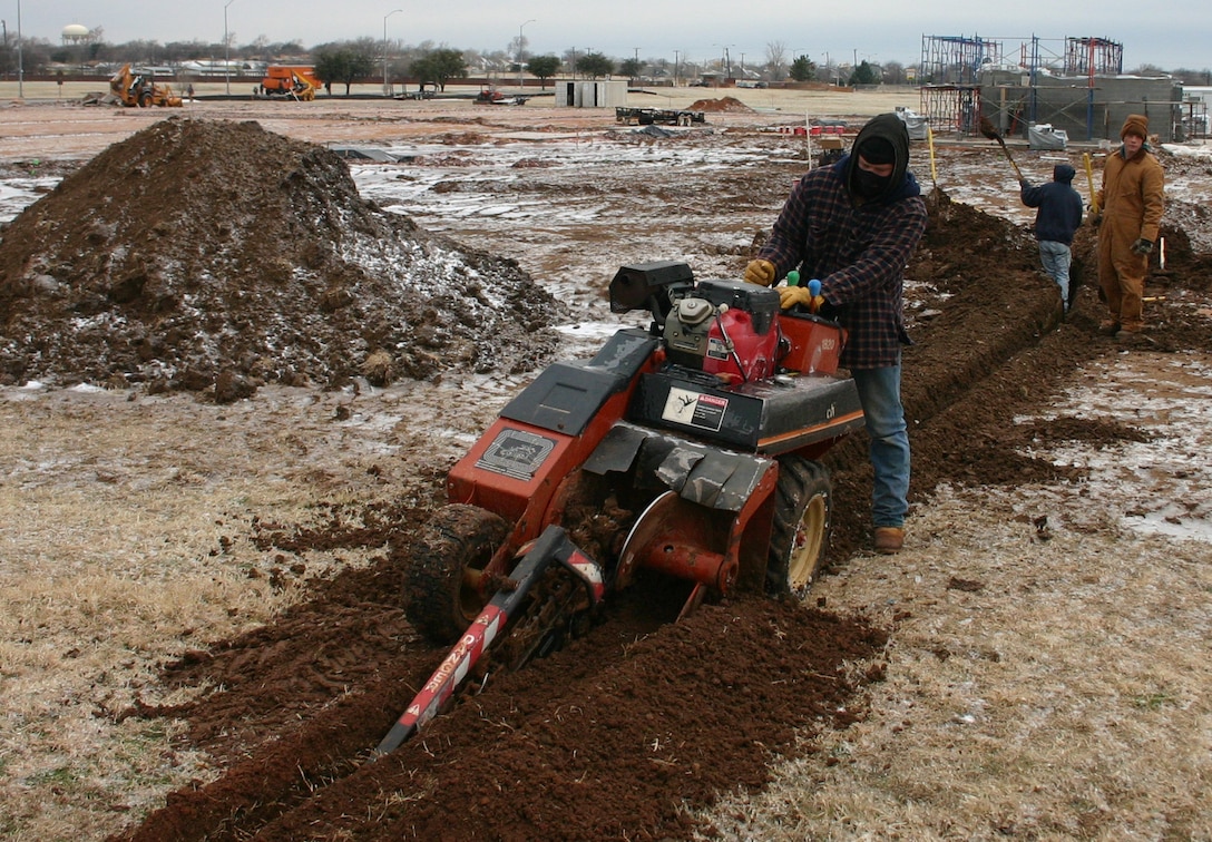 Michael Jackson, a construction worker with Shade Tree Nursery & Landscaping, prepares the ground for installation of a restroom’s water line.  The workers are constructing an athletic field across from the Combat Arms Training Facility. (U.S. Air Force photo/Staff Sgt. Tonnette Thompson.)